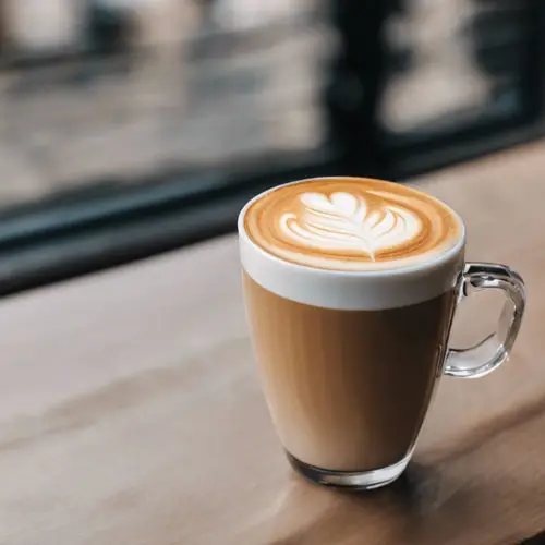 cafe latte on a table by a window