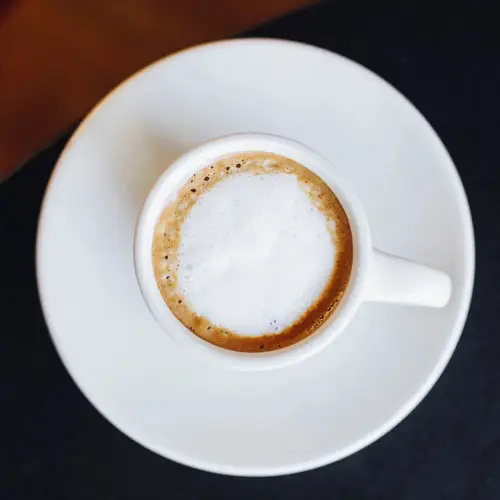 traditional macchiato in a white cup and plate