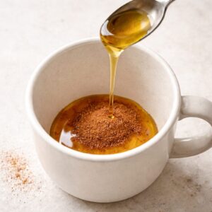 cup with honey and cinnamon at the bottom