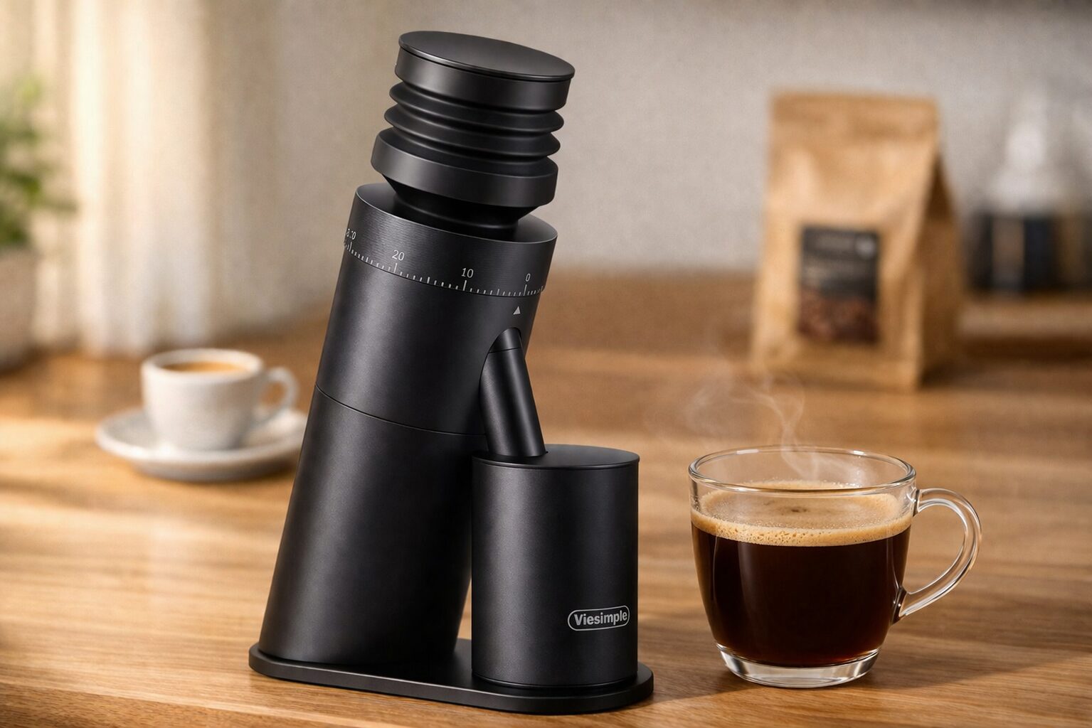 Viesimple Gen 4 burr coffee grinder on a counter next to a freshly brewed cup of coffee